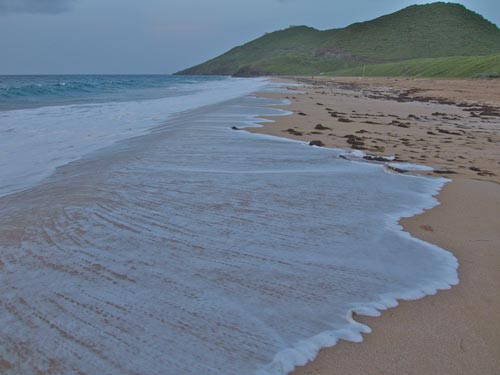 Dusk descends upon a wild beach in St. Kitts.